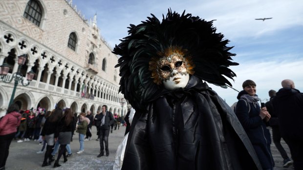 A man wearing a Carnival mask poses in San Marco square during the Venice Carnival last week.