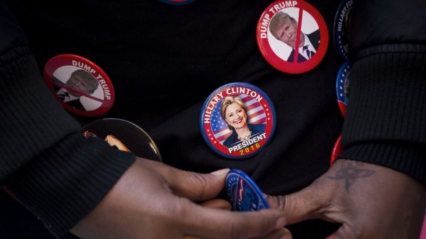 An attendee wears campaign buttons before the start of an event with Hillary Clinton in New York on Wednesday.