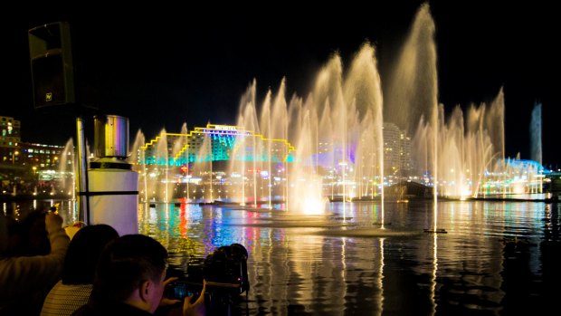 Spectators watch the Aquatique Water Theatre at Darling Harbour during Vivid Sydney in 2014.