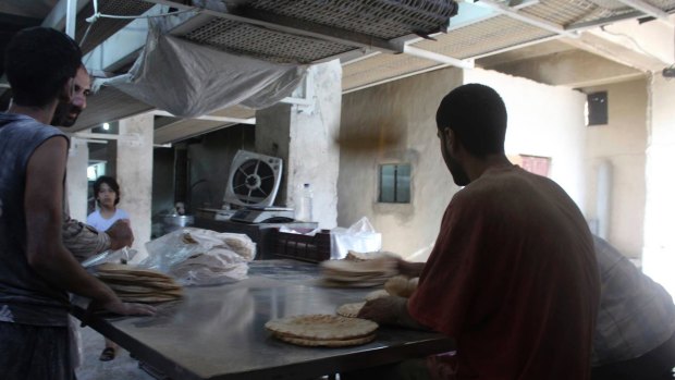 Life goes on amid the bombing for these bakers in Aleppo. 