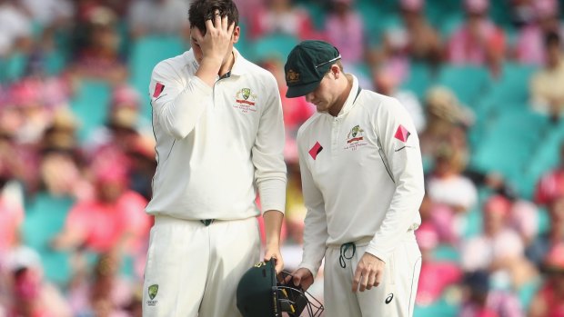 Second knock: Matt Renshaw with Australia skipper Steve Smith after being hit on the helmet while fielding.