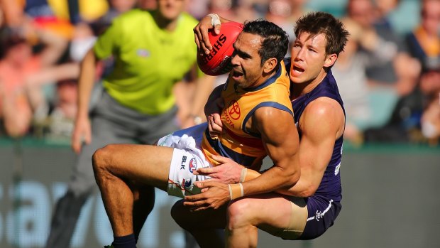Spurr of the moment: Adelaide's Eddie Betts gets wrapped up in a tackle.