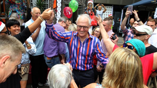 Prime Minister Malcolm Turnbull gets into the festive spirit at the Wayside Chapel in Potts Point.