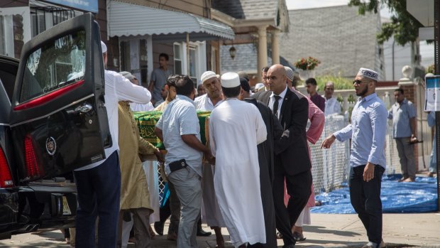 Al-Furqan Jame Masjid mosque members and family of the slain imam Alauddin Akonjee carry his coffin to a hearse during an Islamic funeral prayer in New York.