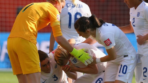 Teammates rush to comfort Laura Bassett after her own goal eliminated England.