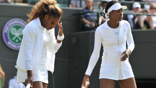 Serena and Venus Williams warm up at Wimbledon earlier this year.