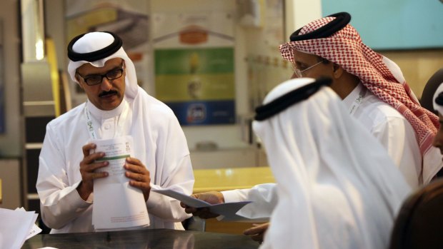 Saudi officials count votes at a polling station in the west coast city of Jeddah.