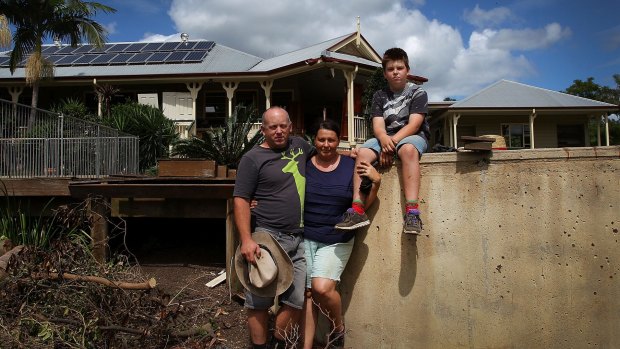 Dan Gallo, Helen Gallo and son Zander Gallo, 11, at their flood damaged barn in Luscombe, where they are now living.