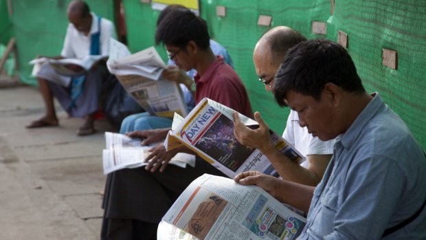 Reading the local newspapers in Yangon on Wednesday. 
