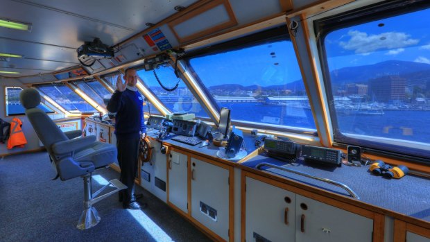 Captain Nathan Clark in the bridge of Coral Expeditions I.