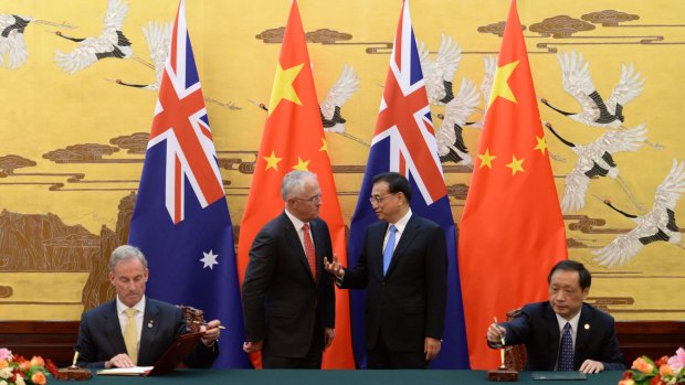Prime Minister Malcolm Turnbull listens to Chinese Premier Li Keqiang  during a ceremony at the Great Hall of the People in Beijing.