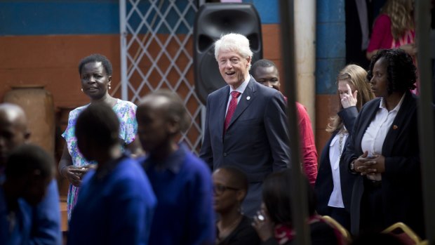 Former President Bill Clinton, centre, and daughter Chelsea Clinton, arrive to speak about their foundation's "No Ceilings" project in Nairobi, Kenya.