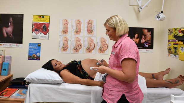 Aboriginal midwife Vanessa Smith checks the position of Kelly's baby three days after her due date at Sutherland Hospital.