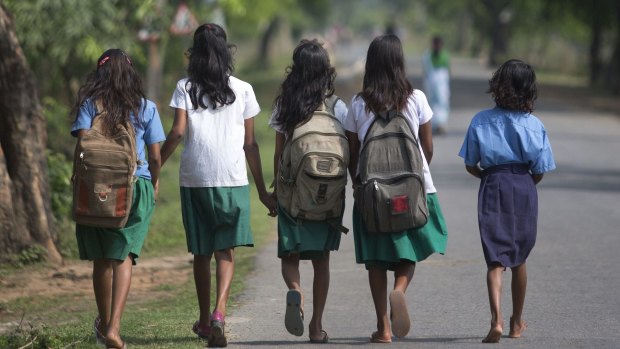Schoolgirls walk to a school at Burha Mayong village east of Gauhati, India.