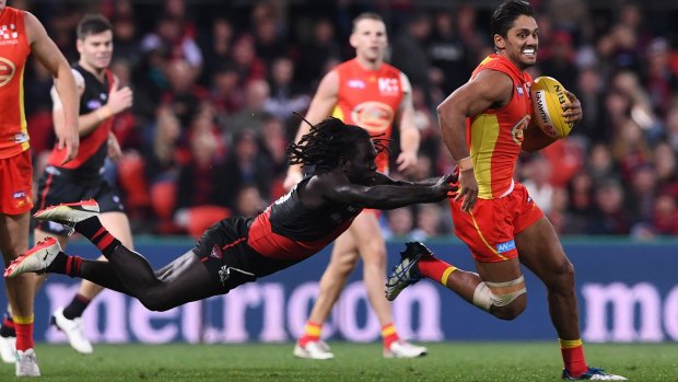 Launching into finals: Essendon's Anthony McDonald-Tipungwuti tackles Gold Coast's Aaron Hall in round 22.