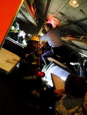 A rescuer searches for injured people inside the derailed Amtrak train in Philadelphia.
