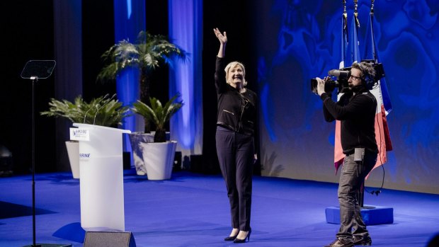 Marine Le Pen, leader of the French National Front, waves to attendees during a presidential campaign event in Lyon.