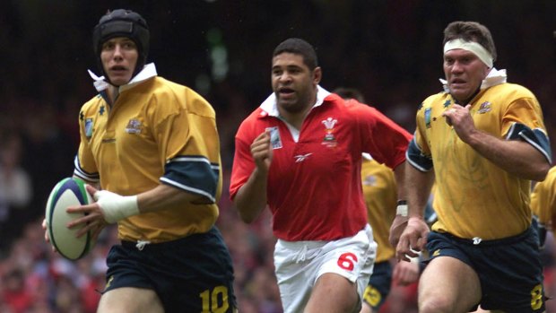Play time: Stephen Larkham makes a break against Wales in the 1999 World Cup.
