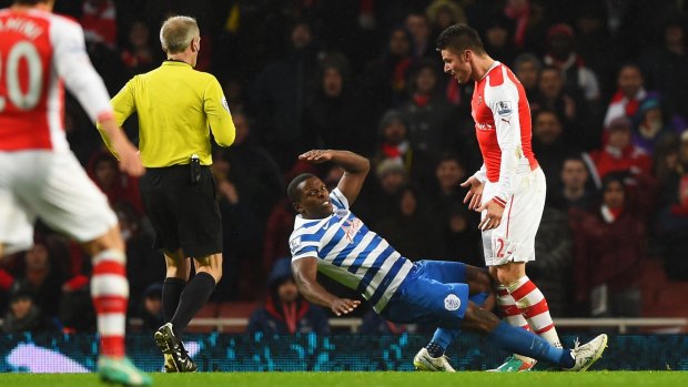 Brain snap: Arsenal's Olivier Giroud reacts to a challenge with QPR's Nedum Onuoha.