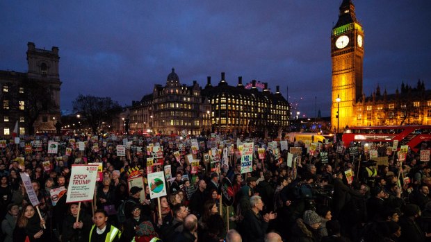 Thousands of protesters holding placards take part in a rally in Parliament Square against US president Donald Trump's state visit to the UK.