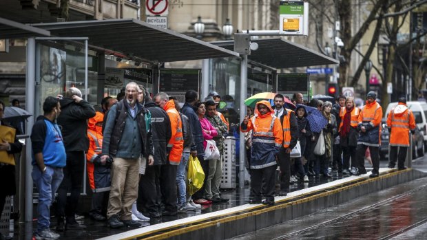 Passengers wait at a tram stop ahead of the most recent tram strike on August 27. 