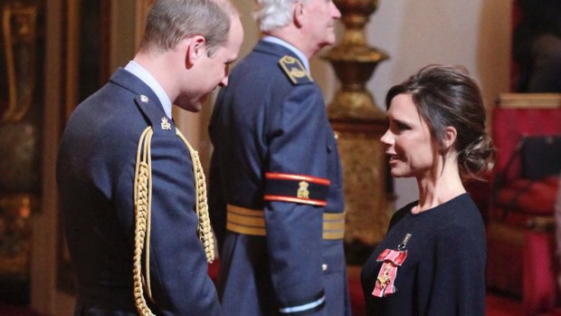 Fashion designer Victoria Beckham receives her OBE from Britain's Prince William, the Duke of Cambridge during an investiture ceremony at Buckingham Palace in London.