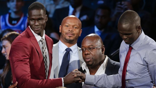 Supporters congratulate Thon Maker, left, at the draft in New York.
