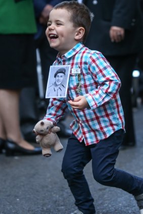 Angus Lansdown, 3, wears a photo of his grandfather, Jack Brice.