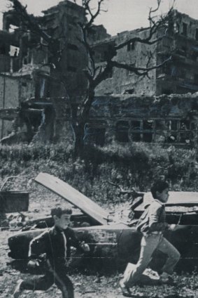 Boys run through a devastated area in the southern suburbs of Beirut, near the 'Green Line' that divided the city, in April 1985.