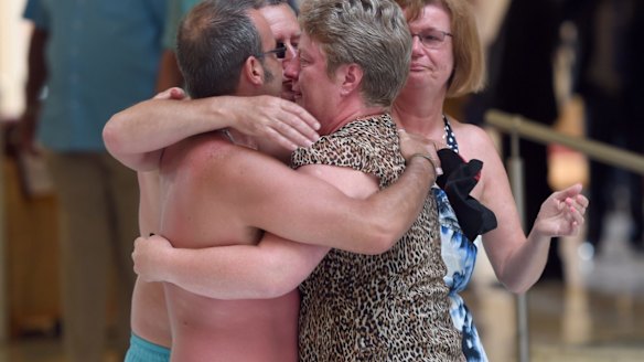 Tourists console each other following the shooting attack.
