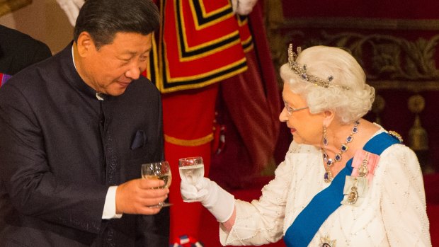Chinese President Xi Jinping and Queen Elizabeth II clink glasses at a state banquet at Buckingham Palace.