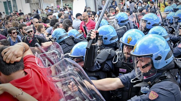 Police charge demonstrators during an anti-G7 rally near the venue of the G7 summit.