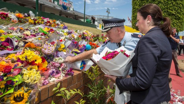 Queensland Premier Annastacia Palaszczuk and police assistant commissioner Brian Codd pay their respects at Dreamworld.