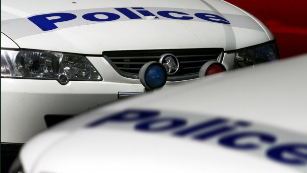 A man was struck on the head with a metal pole after he was approached by a group of robbers.