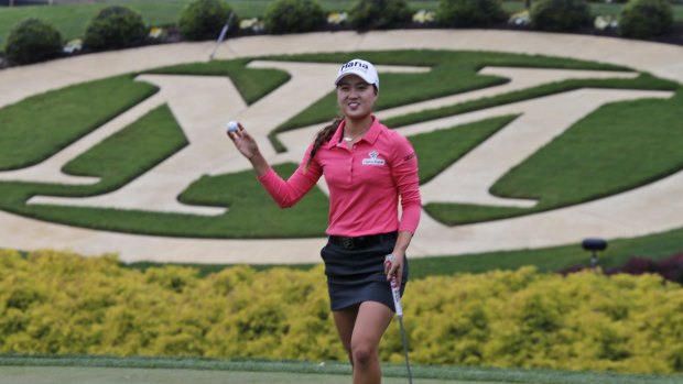 Minjee Lee tips her ball to the crowd after she parred the 18th hole to win the rain-delayed Kingsmill Championship  LPGA golf tournament.
