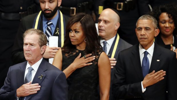 From left, former US president George W. Bush, first lady Michelle Obama and President Barack Obama stand during the interfaith memorial service.