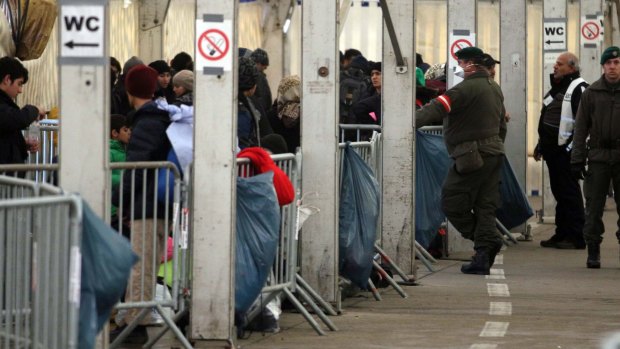 Migrants wait in a registration tent at the border to Slovenia in Spielfeld, Austria, on Tuesday. 