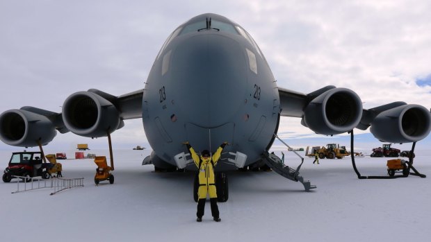 Central Queensland University student Kate Senekin, who has spent nearly a year in Antarctica, with a C17 at Wilkins Runway near Casey Station.