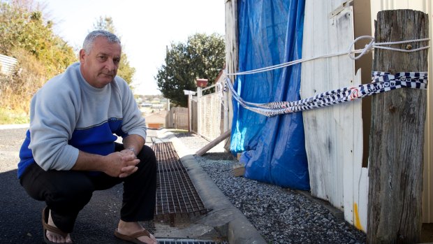 Garry Burrows, outside his mother's garage where his brother, John, was killed.