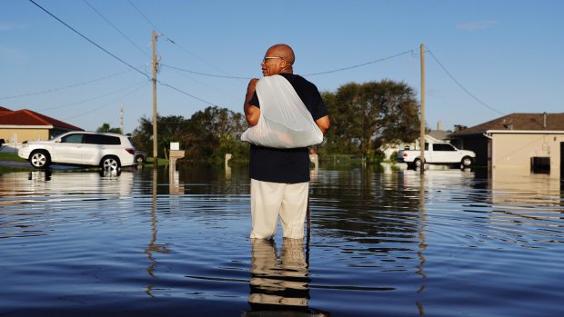 Jean Chatelier walks through a flooded street from Hurricane Irma in Fort Myers, Florida.
