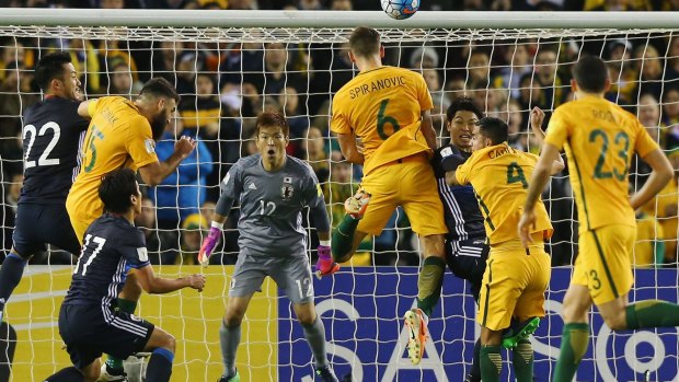 Off target: Matthew Spiranovic misses a header attempt for goal against Japan. The Socceroos will play Thailand in Bangkok on November 15.