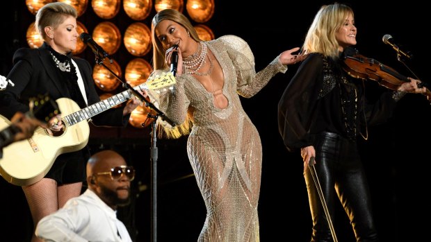 Beyonce wears a J'Aton dress as she performs with the Dixie Chicks at the Country Music Awards in Nashville on Wednesday.