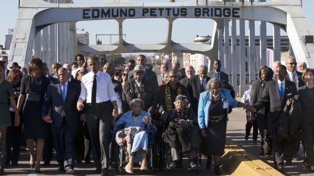 Singing <i>We shall overcome</i>, marchers in Selma led by President Barack Obama commemorate the 50th anniversary of the "Bloody Sunday" protest.