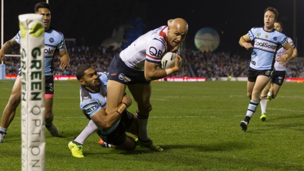 Key figure: Blake Ferguson scores during the Roosters' late win over the Sharks on Saturday.