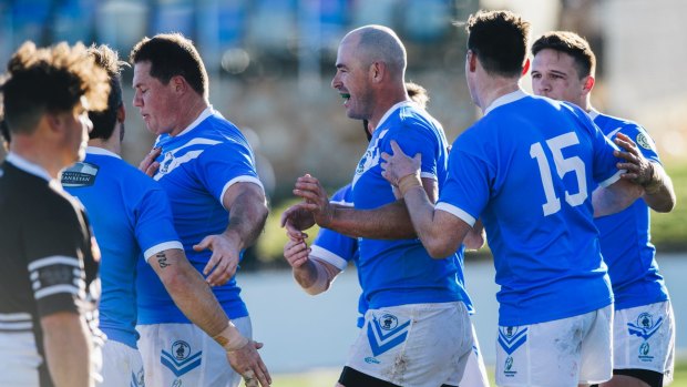 Terry Campese (centre) celebrates a Queanbeyan try with teammates in the Blues' Canberra Raiders Cup preliminary final win over the Yass Magpies on Sunday.