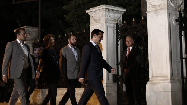 Alexis Tsipras, Greece's prime minister, second right, arrives at the presidential palace before meeting with Greek President Prokopis Pavlopoulos on Thursday