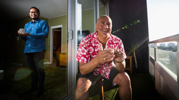 Mario Cacchione (centre) poses for a photo with Gerry Wahyu Nugraha of Indonesia who is a guest in the spare room of his CBD property that he rents out through Airbnb 