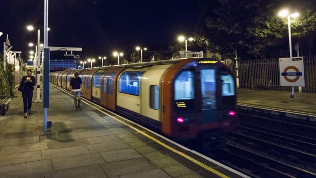 Passengers disembark a Night Tube at Leyton Underground Station.