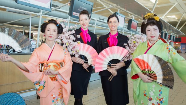 Qantas staff celebrating flights into Asia at Brisbane Airport.