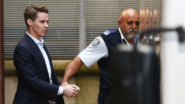 Insider trader Oliver Curtis is escorted to a prison truck after being sentenced to two years in jail.